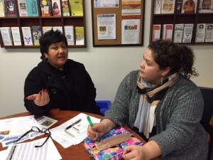 Esther Rosario, an independent consultant for the Orland schools,, discusses the immigration fair with Neli Peña of Orland Unified.
