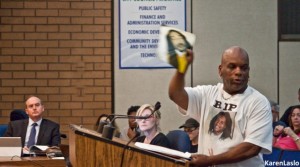 photo by Karen LasloDave Phillips waved a picture of his son, the late Desmond Phillips, while speaking to the Chico City Council at its April 5 meeting.